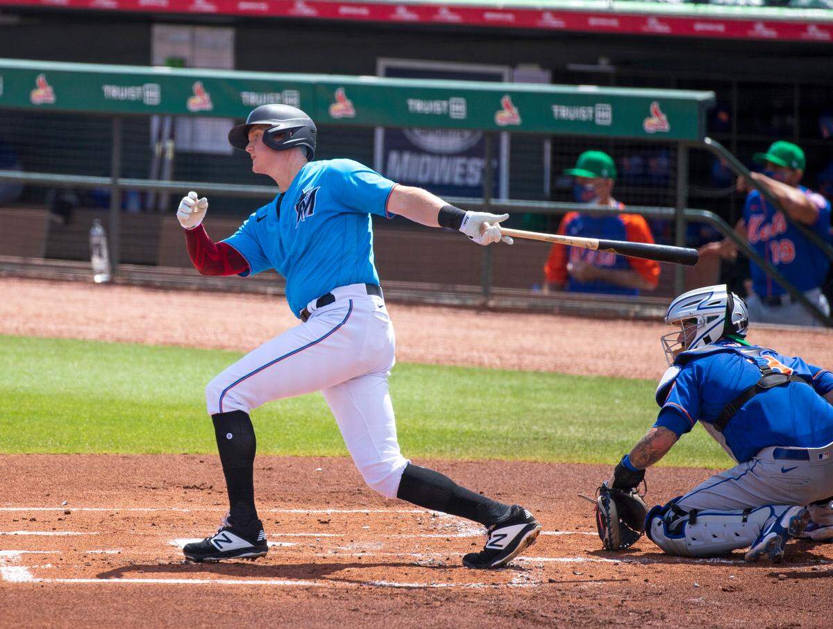 Miami Marlins right fielder Garrett Cooper (26) batting during the first inning of their spring training baseball game against the New York Mets at Roger Dean Chevrolet Stadium on Wednesday, March 17, 2021 in Jupiter, Florida.