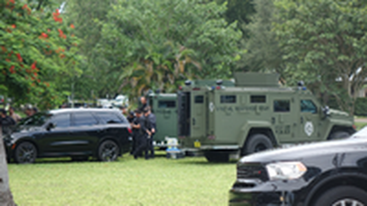 Miami-Dade Police Special Response Team members swarmed the Extended Stay America hotel in Miami Springs on Aug. 16, 2022, before a man suspected of an armed robbery was killed by police.
