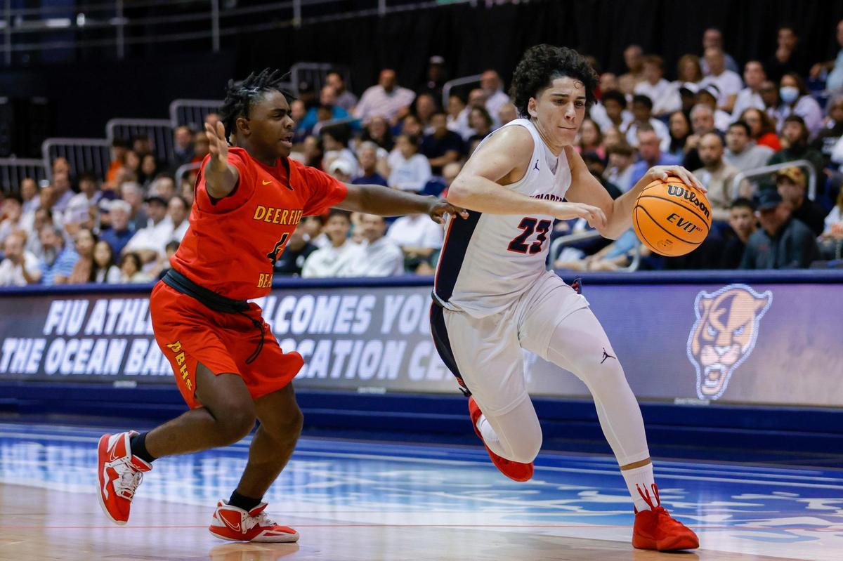 Columbus shooting guard Benny Fragela (23) drives to the basket during the second half of the basketball regional final against Deerfield Beach at the Ocean Bank Arena at Florida International University in Miami, Florida, Friday, February 24, 2023.