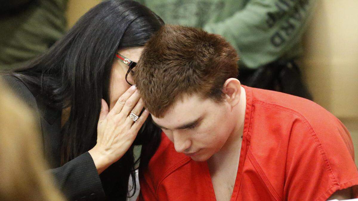 Assistant Public Defender Erin Veit, left, talks with school shooting suspect Nikolas Cruz in a Broward County courtroom for a hearing in Fort Lauderdale on Friday, Aug. 3, 2018. Attorneys for Cruz want a judge to prevent release of details of his education records to guarantee a fair trial. Cruz faces the death penalty if convicted of killing 17 people in the Valentine’s Day attack at Marjory Stoneman Douglas High School.