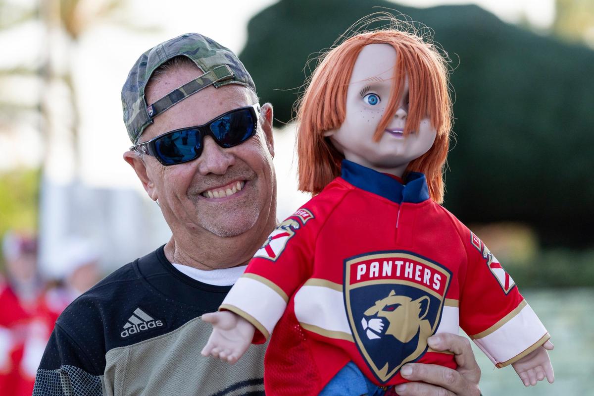 Florida Panthers fan Monty Pike, 64, holds a chucky doll as he arrives to a watch party at the Amerant Bank Arena before his team plays against the Edmonton Oilers in Game 6 of the NHL Stanley Cup Final on Friday, June 21, 2024, in Sunrise, Fla.