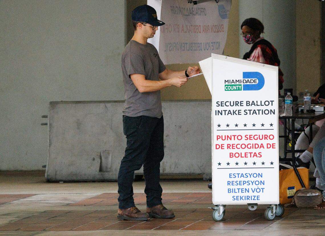 A man drops off his mail in ballot on Election Day on Tuesday, Nov. 5, 2024, at Stephen P Clark Government Center in downtown Miami.