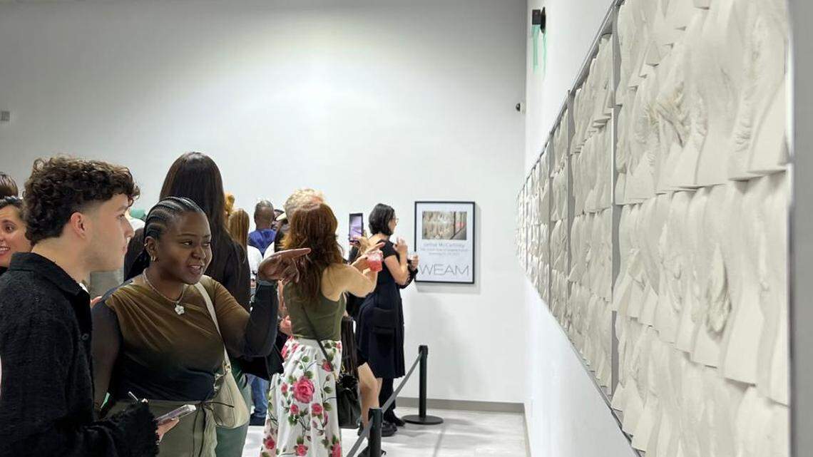 Visitors at the Wilzig Erotic Art Museum in Miami Beach examine artist Jamie McCartney’s “The Great Wall of Vulva” at the opening of the show during Miami Art Week.