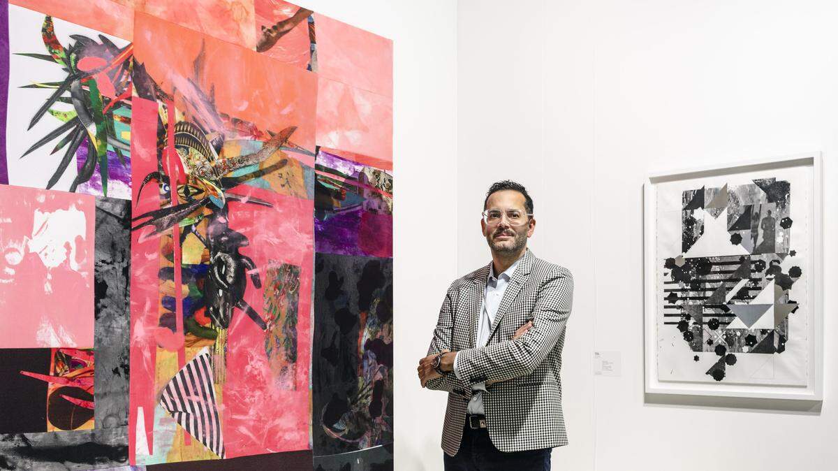 David Castillo, owner of David Castillo Gallery on Lincoln Road in Miami Beach, stands in front of his booth in the “Galleries” sector at Art Basel Miami Beach at the Miami Beach Convention Center. The artwork, from left to right, is by artists Pepe Mar and Adler Guerrier.