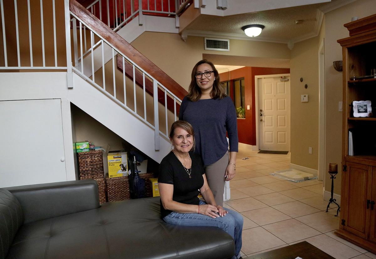 Martha Zafra (seated) and Martha Falero are residents of a two-story condo for sale in the Celebration Point community in Miami Lakes. Both say they like the city, but have outgrown the 1,240-square-foot, 2-bedroom, 2-bath condo. Property for sale at 5499 Miami Lakeway N, #5, Hialeah, FL 33014 on Tuesday July 2nd, 2019. Both mother and daughter say they love Miami Lakes.