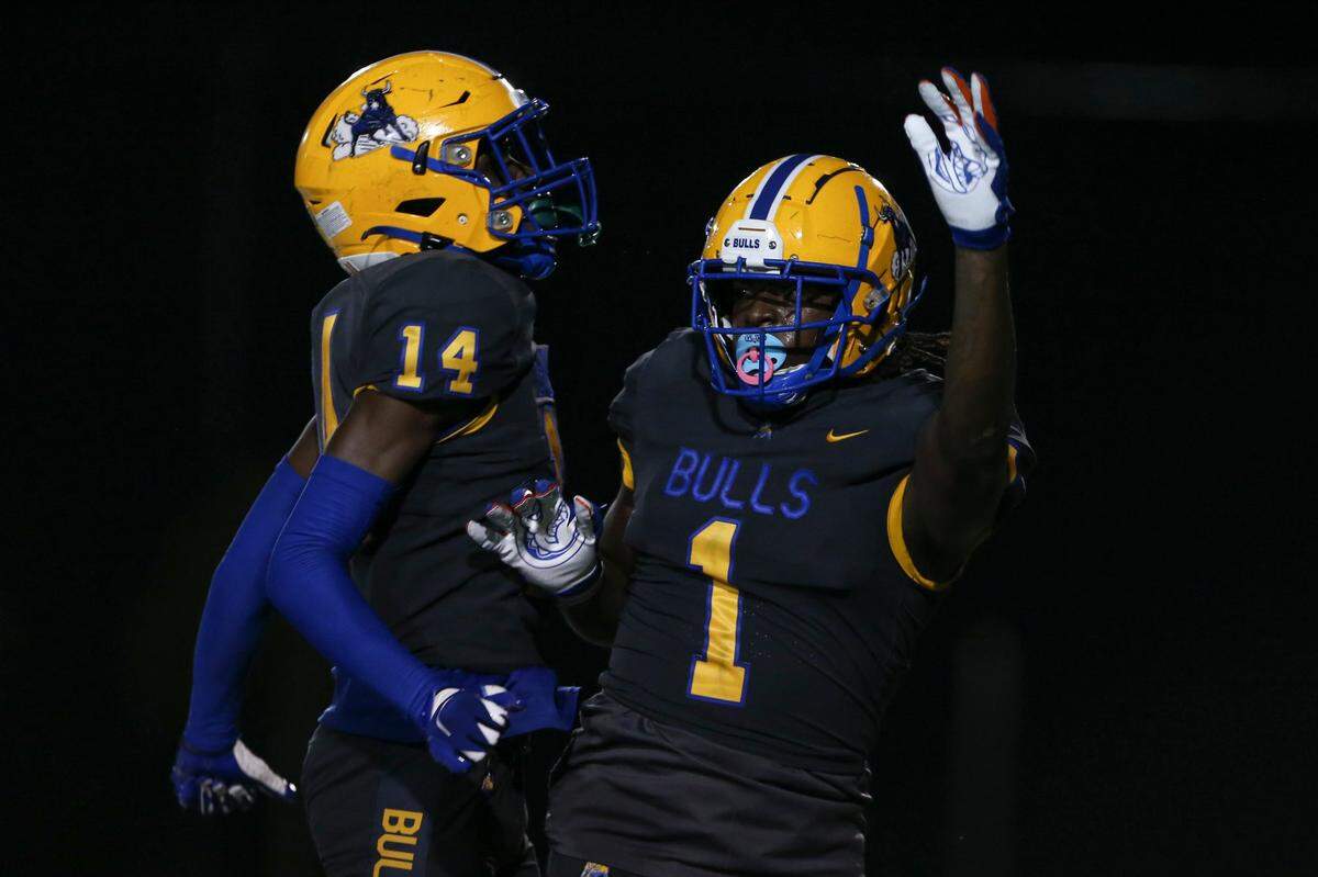 Northwestern Bulls Adam Moore (1) celebrates with wide receiver Calvin Russell (14) after scoring a touchdown during the third quarter against the Jackson Generals of a high school football game at Traz Powell Stadium in Miami, Florida, on Friday, September 1, 2022.