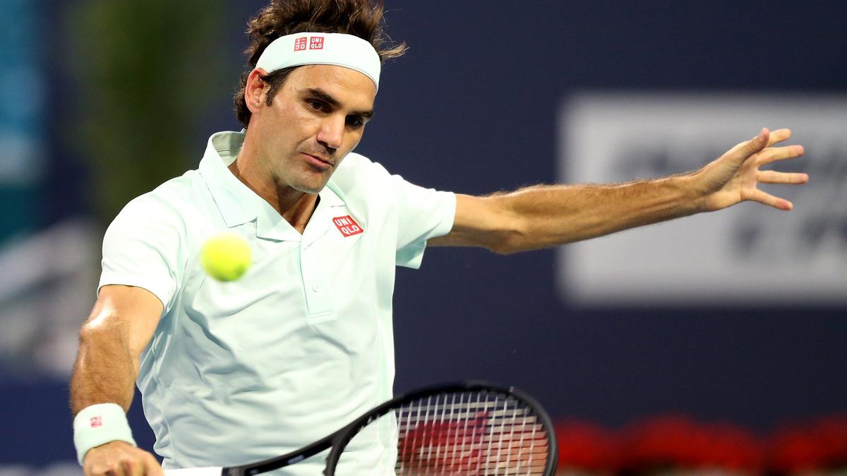 Roger Federer returns ball hit by Denis Shapovalov in the semi-finals at the 2019 Miami Open at Hard Rock Stadium in Miami Gardens, Florida, Friday, March, 29, 2019.