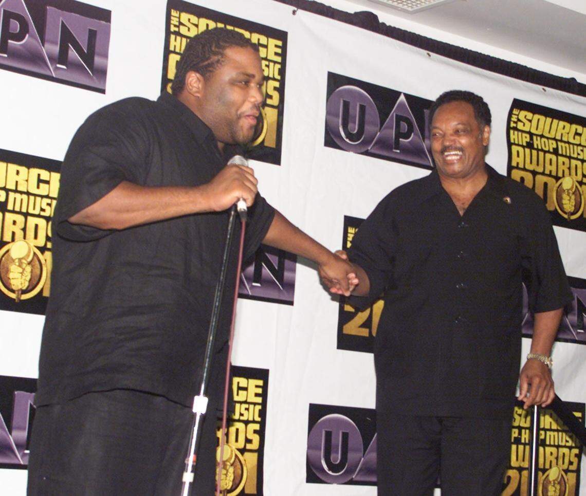 In 2001, comedian Anthony Anderson greets the Rev. Jesse Jackson as he makes his way up the stage at The Source Hip-Hop Awards in Miami Beach..