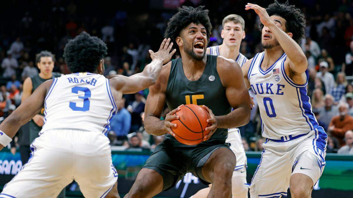 Miami Hurricanes forward Norchad Omier (15) drives the ball as Duke Blue Devils guard Jeremy Roach (3) and Duke Blue Devils guard Jared McCain (0) defend in the first half at the Watsco Center In Coral Gables, Florida on Wednesday, February 21, 2024.