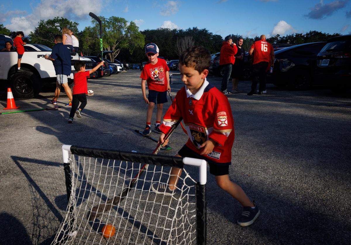 Liam Carr, 4, and friends play hockey in the parking lot at a tailgate before Game 5 of the NHL Stanley Cup Final at the Amerant Bank Arena.