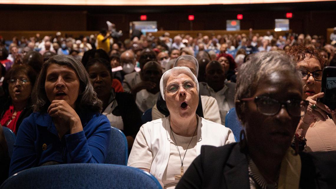 A nun and others shout “Let Justice Roll!” during PACT’s assembly addressing skyrocketing rents and reducing arrests for those driving with a suspended license. The interfaith group invites elected officials to the rally to hear about proposed solutions.