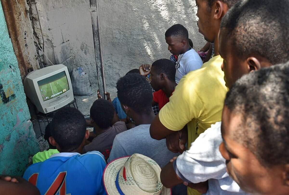 Haitians crowd before a small television set watching the telecast of the Russia 2018 World Cup quarter-final football match between Brazil and Belgium in a neigborhood of Port-au-Prince on July 6, 2018. (Photo by HECTOR RETAMAL / AFP via Getty Images)