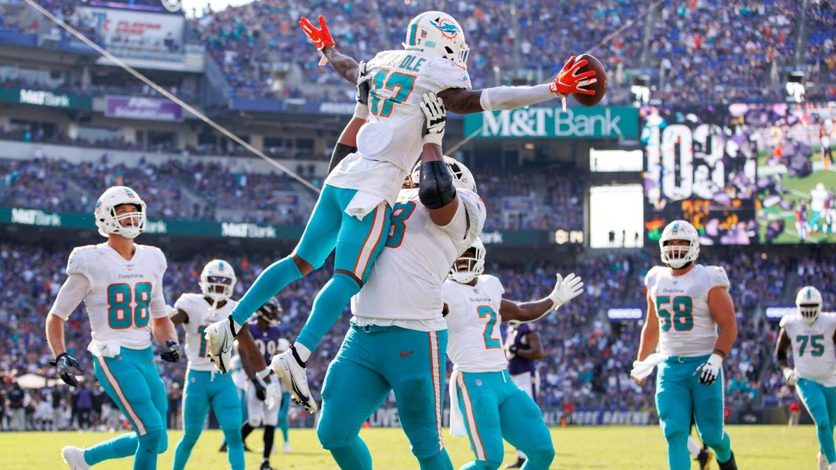 Miami Dolphins wide receiver Jaylen Waddle (17) celebrates with teammates Robert Hunt (68) Mike Gesicki (88) Chase Edmonds (2) and Connor Williams (58) after scoring the go ahead touchdown during the fourth quarter of an NFL football game against the Baltimore Ravens at M&T Bank Stadium on Sunday, September 18, 2022 in Baltimore, MD.