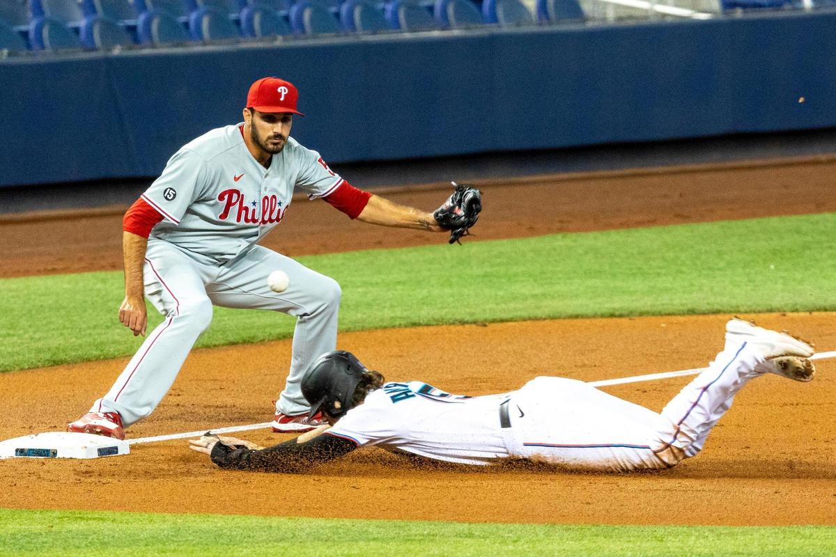  Brian Anderson slides safely into third base as the throws gets away from&nbsp;Phillies pitcher Zach Eflin in the second inning Monday.