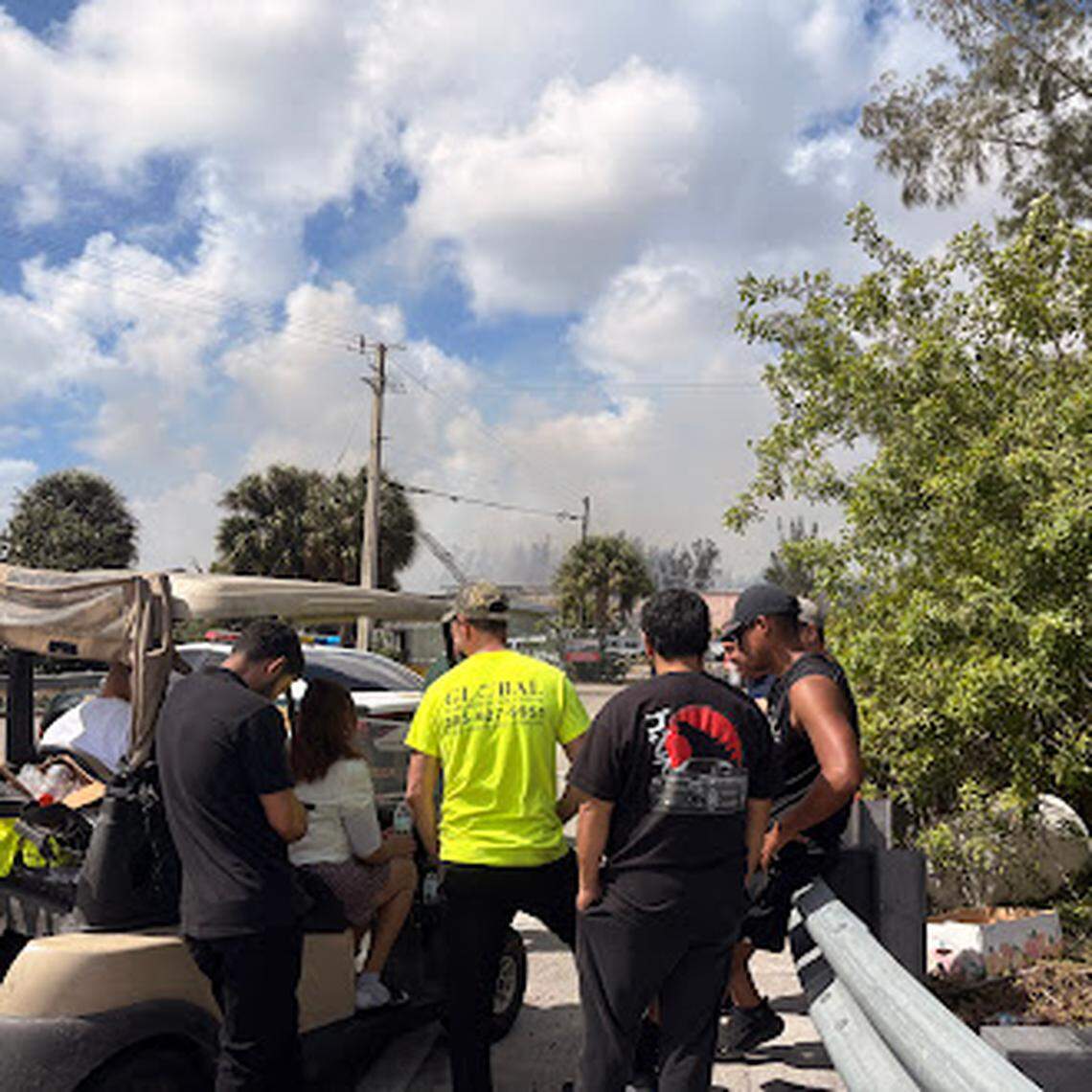 Warehouse workers wait at the Northeast 47th Avenue entrance to pick up their cars on Friday March 6, 2026.