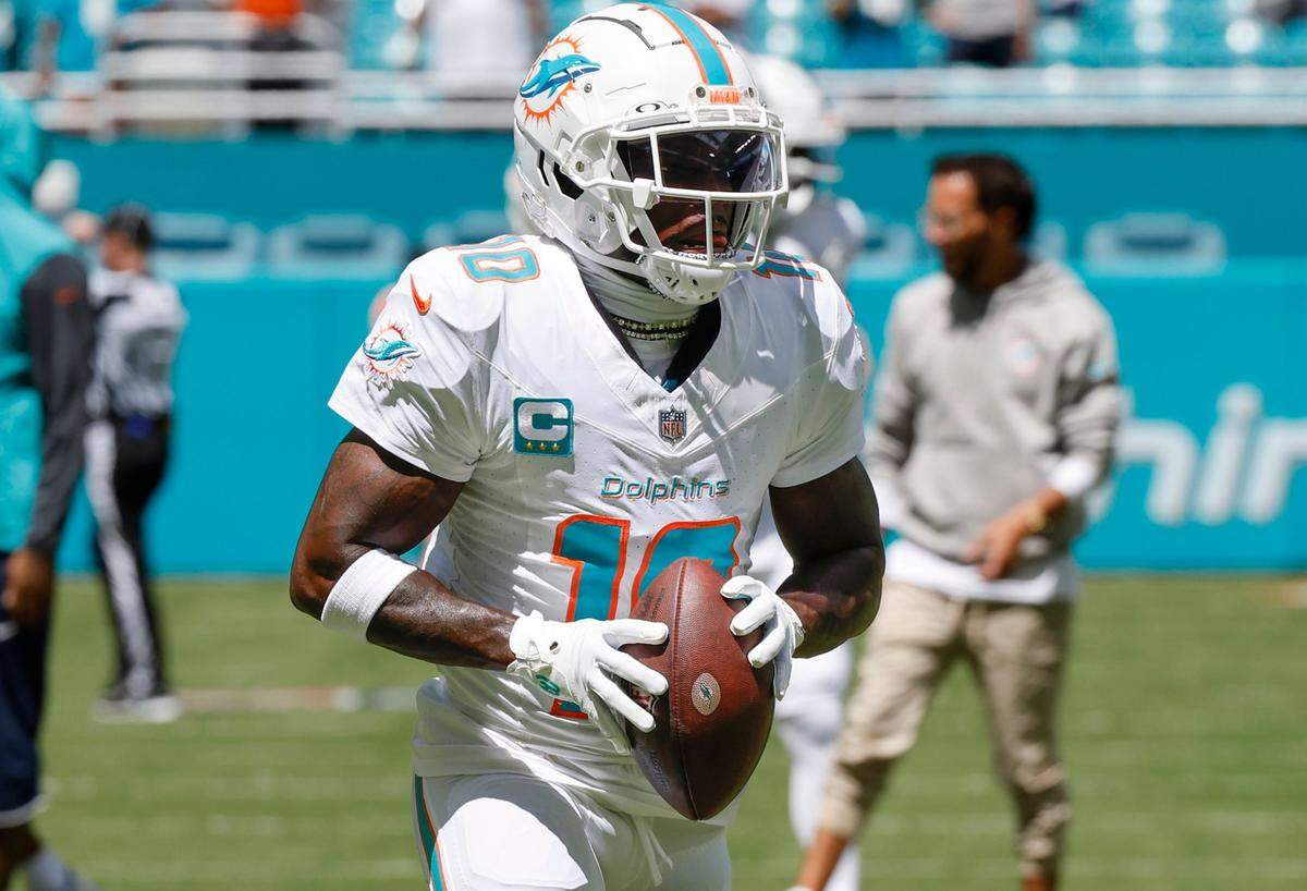 Miami Dolphins wide receiver Tyreek Hill warms up before the start of an NFL football game against the Jacksonville Jaguar at Hard Rock Stadium.