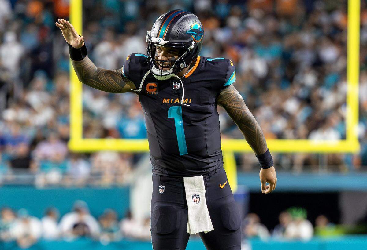 Miami Dolphins quarterback Tua Tagovailoa (1) reacts after tight end Darren Waller (83) scores his second touchdown against the New York Jets during the second half of an NFL football game Monday, Sept. 29, 2025, in Miami Gardens, Fla.