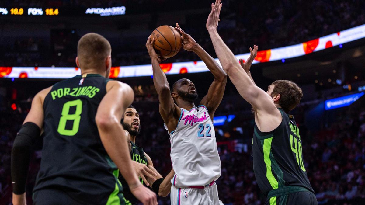 Miami Heat forward Andrew Wiggins (22) attempts to shoot over Boston Celtics center Luke Kornet (40) during the first half of an NBA game at Kaseya Center on Monday, February 10, 2025, in Miami, Fla.