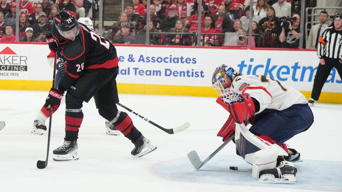 May 20, 2025; Raleigh, North Carolina, USA; Florida Panthers goaltender Sergei Bobrovsky (72) blocks a shot as Carolina Hurricanes forward Sebastian Aho (20) looks on during the first period in game one of the Eastern Conference Final of the 2025 Stanley Cup Playoffs at Lenovo Center. Mandatory Credit: James Guillory-Imagn Images