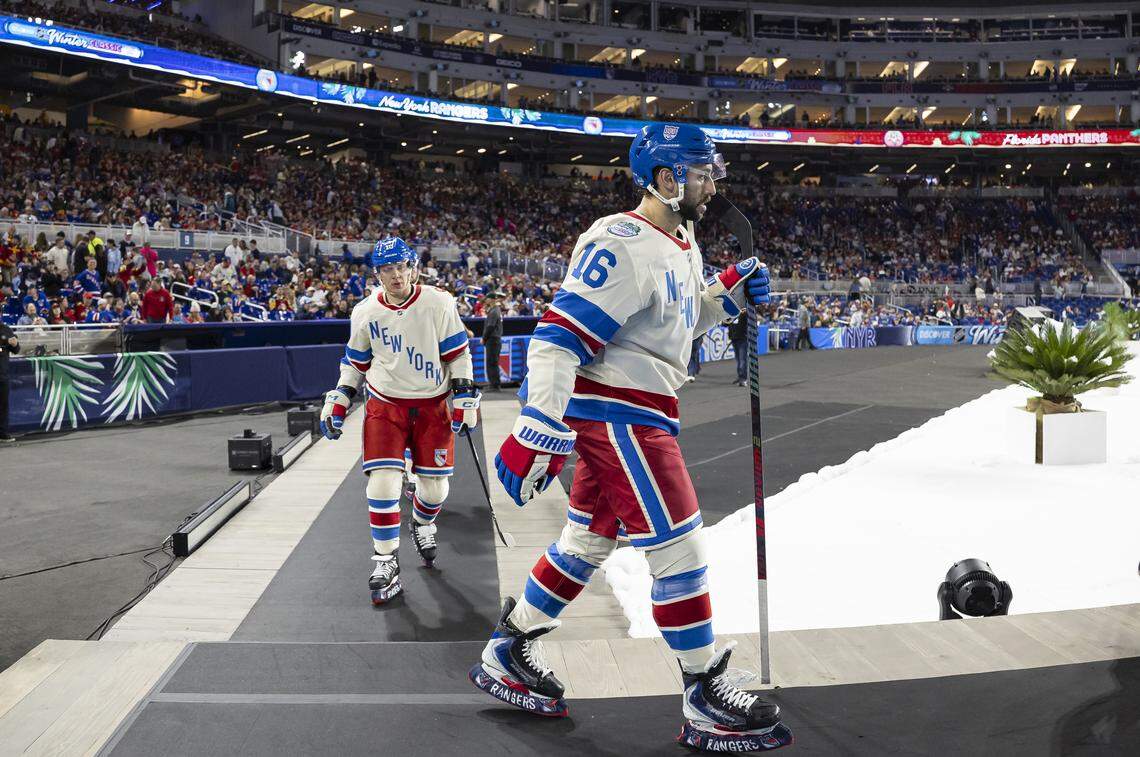 New York Rangers center Vincent Trocheck (16) and left wing Artemi Panarin (10) make their way back into the rink before the second period of their Winter Classic outdoor hockey game against the Florida Panthers at loanDepot park on Friday, Jan. 2, 2026, in Miami, Fla.