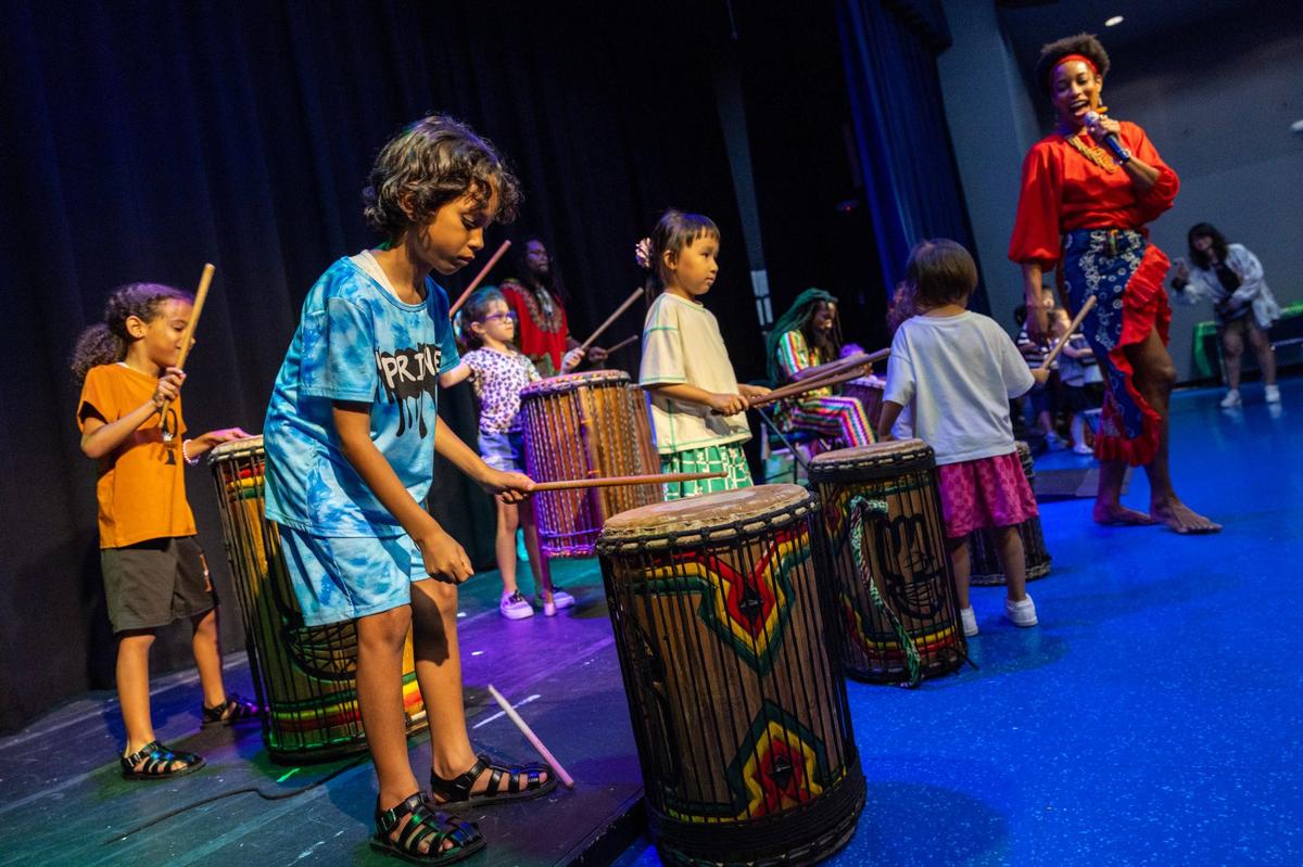 Kids participate by drumming along to the beat during a traditional African dance show led by Maryann Arnita Payne during a Juneteenth celebration at Miami Children’s Museum on Wednesday, June 19, 2024.