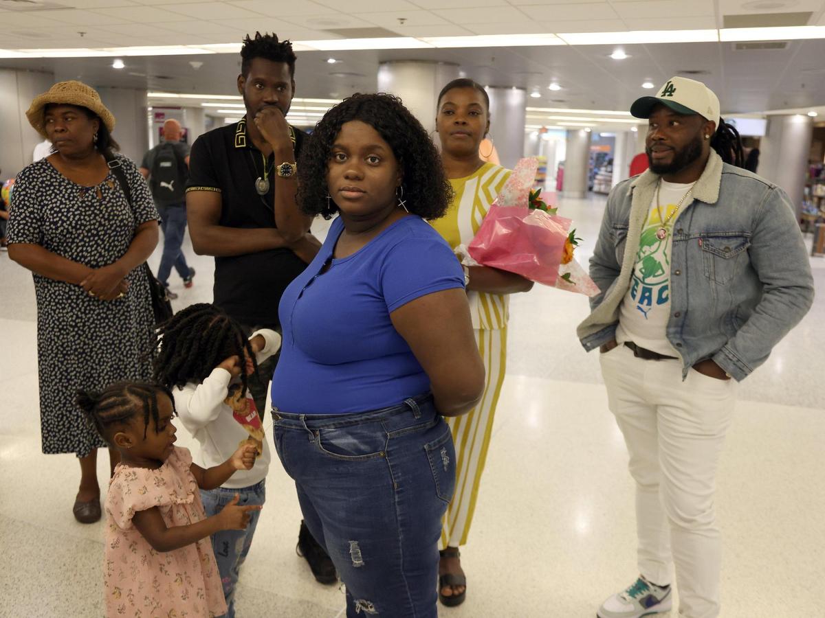 Roselore Touze, in blue, awaits her sister Jeanine Touze on March 25, 2024, at Miami International Airport. To her right, Samuel Paulemon, also awaits his family. Both had relatives coming from Haiti as part of the two-year humanitarian parole program launched in January 2023 by President Joe Biden.