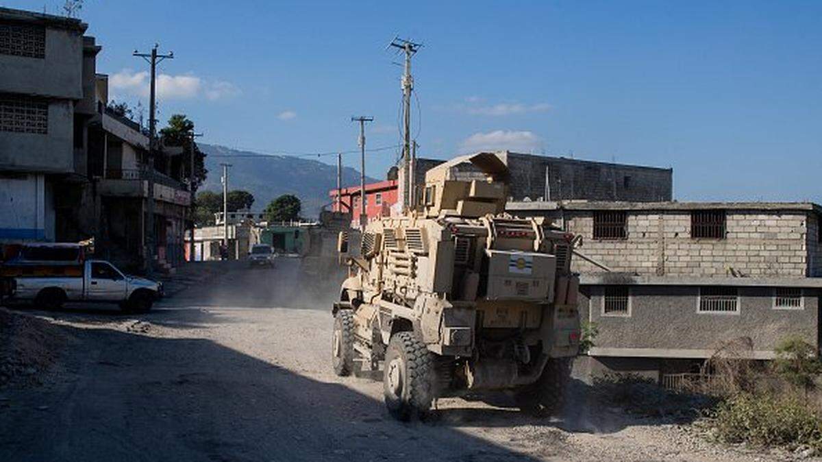An armored police vehicle patrols through the Bas-Delmas neighborhood in Port-au-Prince, Haiti, on Feb. 13, 2026. 