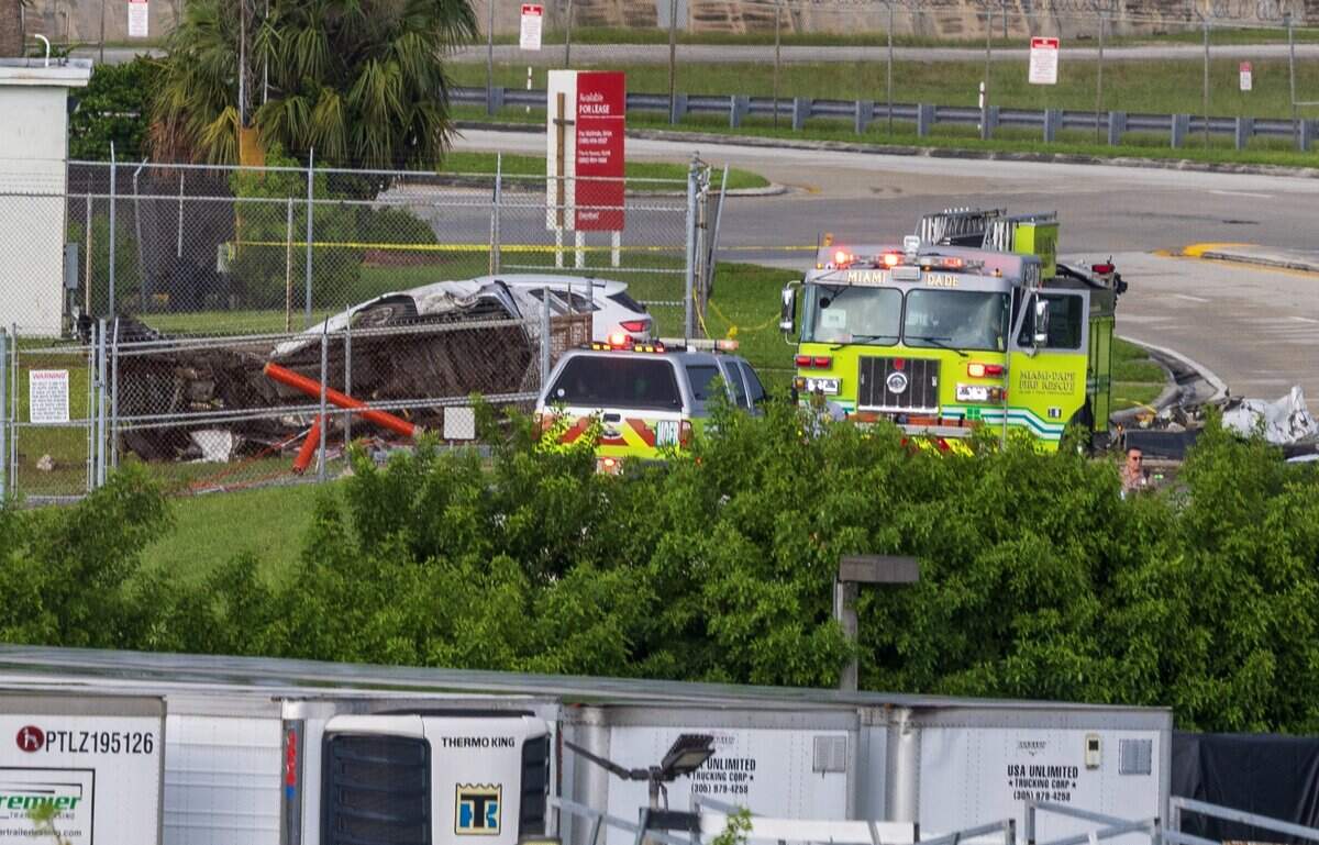 View of Miami- Dade firefighter units next to a vehicle crushed (left side) by an Amazon cargo plane that crashed at Miami International Airport Sunday afternoon, causing a full ground stop that halts all flights, on Sept. 6, 2026.