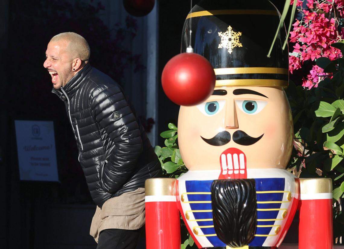 A South Beach restaurant employee shares a laugh and keeps warm as the rising sun warms them, after temperatures dipped due to an arctic blast. An arctic blast moved into South Florida late Tuesday, bringing a sharp overnight temperature drop. Visitors and residents alike promenade in hoodies, sweaters, coats, and other cold-weather gear on Ocean Drive as breezy north winds made it feel colder through New Year's Eve and New Year's Day. Morning lows were in the upper 40s to low 50s, with daytime highs near the low 70s on Wednesday, December 31, 2025, in Miami Beach, Florida.