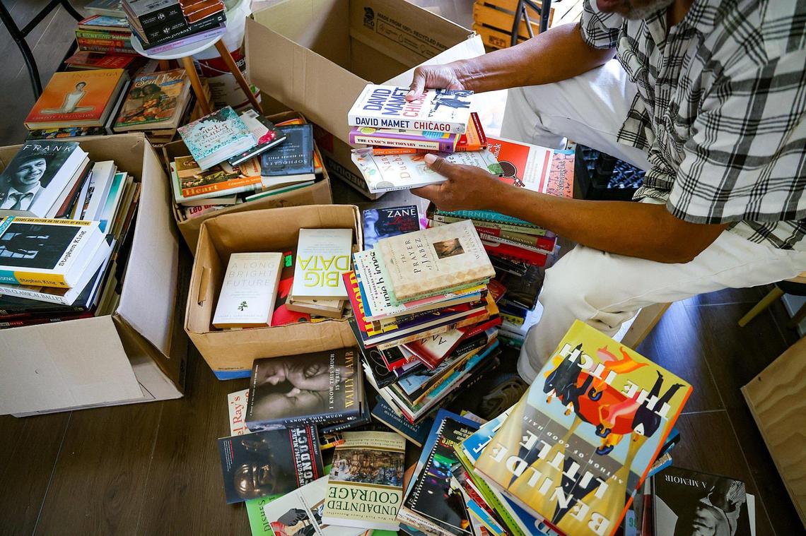 Barney Agnew, 71, the father of the late Danny Agnew, helps sort through the thousands of books that will be sold at the new Roots Bookstore and Marketplace in Liberty City. Roots Bookstore and Marketplace, the brainchild of the late Danny Agnew, is set to open on Juneteenth, thanks to the hard work of his brother Phillip Agnew, Sherina Jones, Isaiah Thomas, and a team of volunteers.