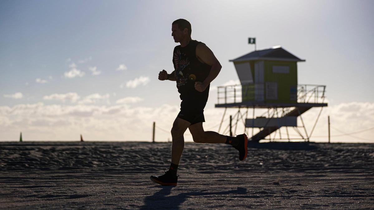 Mika Shevit, 48, who will be running in the half-marathon portion of this year’s Miami Marathon, jogs through Haulover Beach on Thursday, Jan. 19, 2023 in Miami Beach, Fla. Shevit has been running a half marathon for more than 650 days consecutively and is looking to reach at least a 1000-day streak.