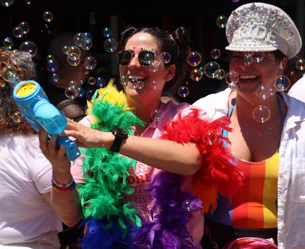 Sisters Sam, left, and Katrina Vastos from Colorado enjoy the parade with the aid of bubbles.
