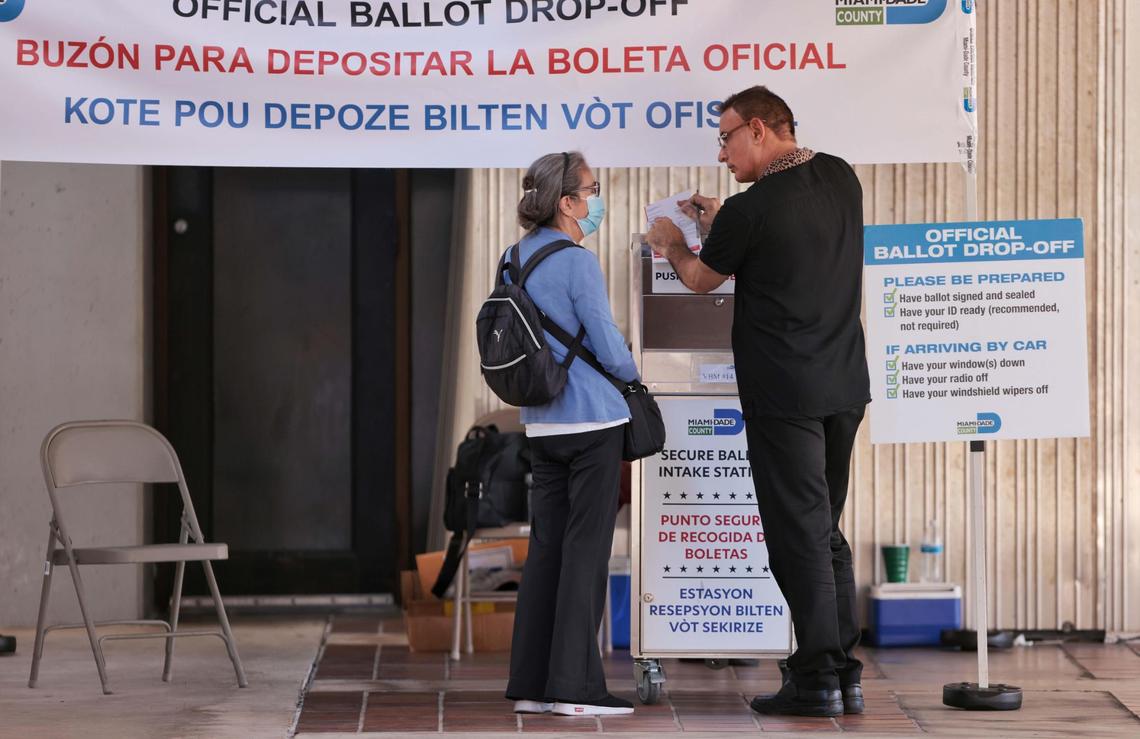 A Miami-Dade resident gets assistance from a poll worker in dropping off her ballot at Stephen P. Clark Government Center in downtown Miami, Florida, during the Florida Democratic Primary on Tuesday, August 23, 2022.