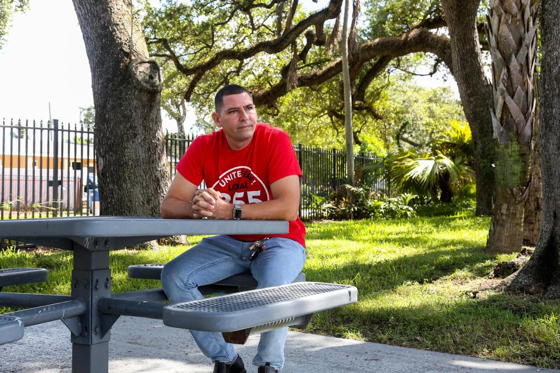who has worked as a doorman at the Diplomat Beach Resort for the past 16 years, sits at a picnic table outside the office building of Unite Here Local 355 in Miami Gardens, Florida, on Friday, Aug. 20, 2021.
