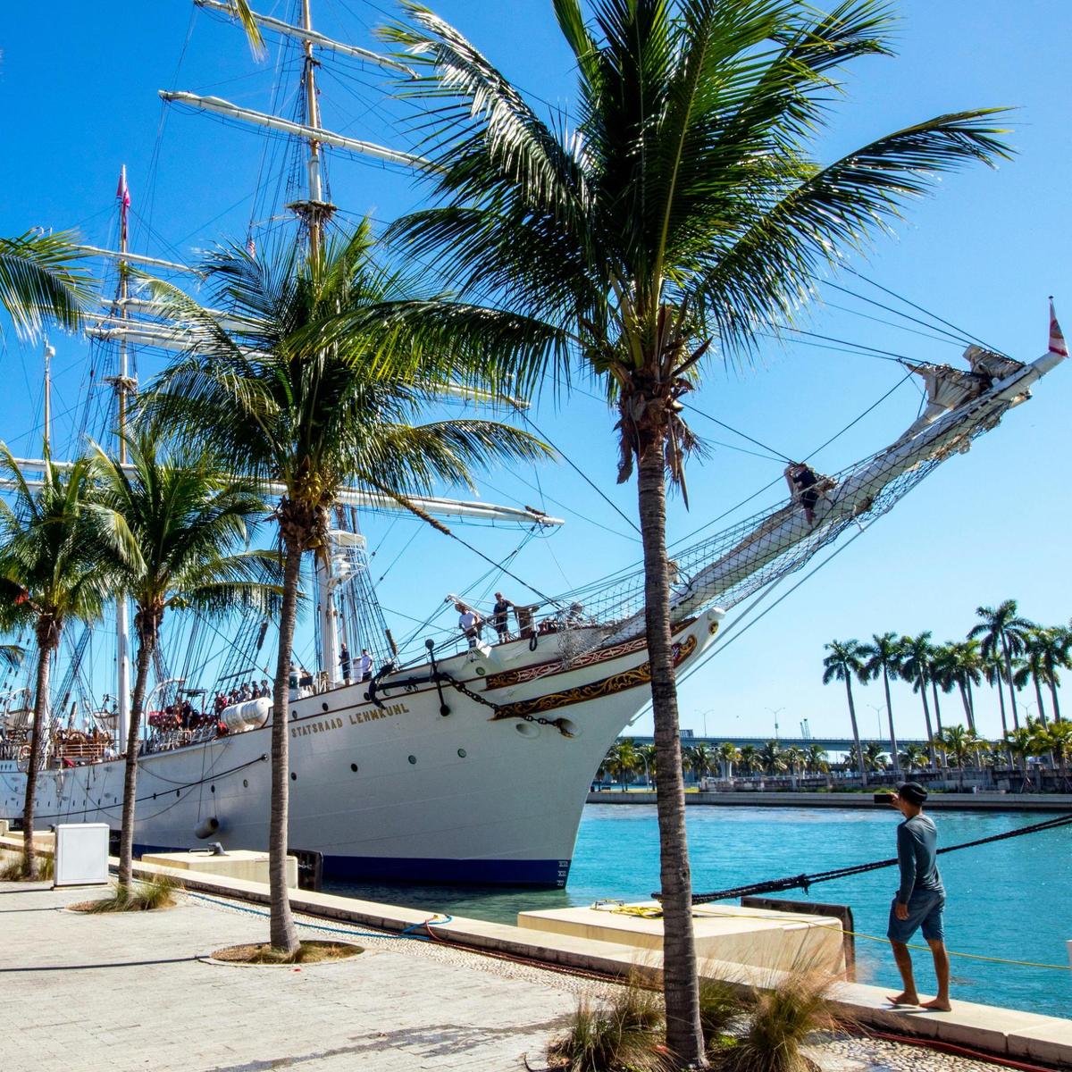 A man takes a photo with his phone of the Norwegian tall ship, Statsraad Lehmkuhl, while it is docked near FTX Arena in Miami on Tuesday, Dec. 7, 2021.