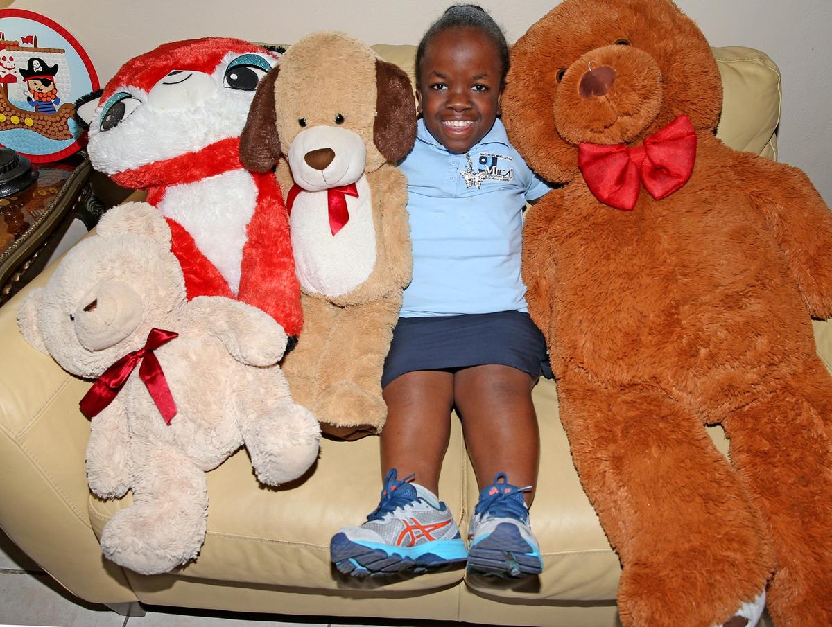 Gloria Alexandre, 13, with her stuffed animals in her North Miami apartment on Nov. 22, 2019. Born in Haiti in 2006, Gloria was diagnosed with a genetic disease known as achondroplasia dwarfism. Gloria’s wish is for a laptop to do her homework.