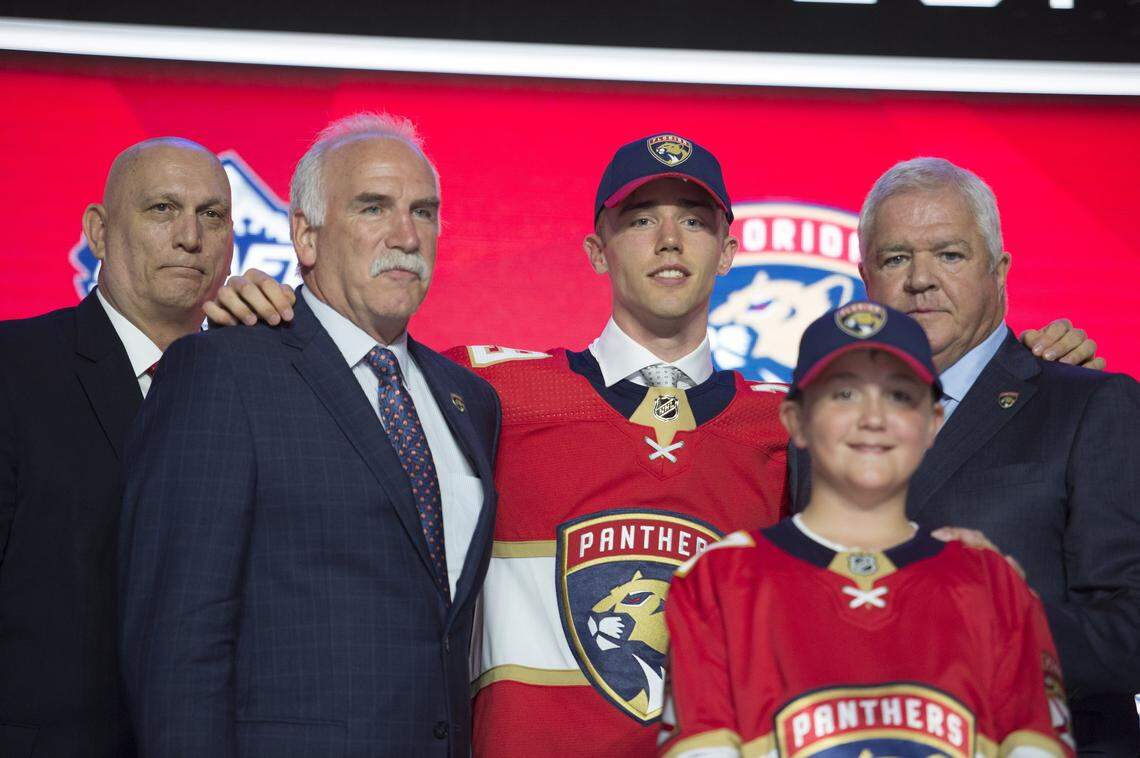 Florida Panthers draft pick Spencer Knight stands next to Panthers coach Joel Quenneville, left, during the first round of the NHL hockey draft Friday, June 21, 2019, in Vancouver, British Columbia. (Jonathan Hayward/The Canadian Press via AP)