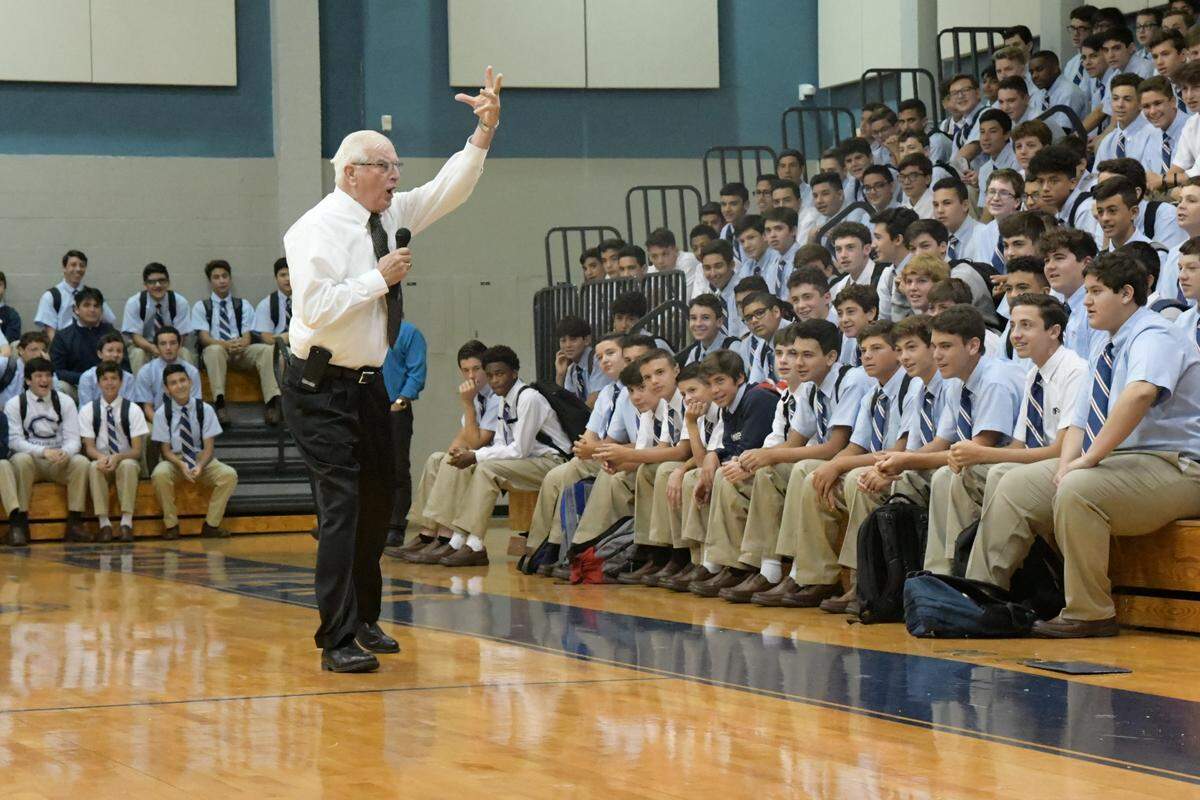 Br. Kevin Handibode leads a cheer at the Columbus High School gym in 2018.