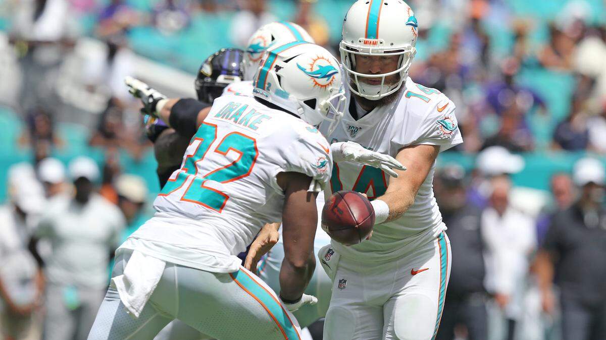 Miami Dolphins quarterback Ryan Fitzpatrick (14) hand off to running back Kenyan Drake during second quarter of an NFL football game against the Baltimore Ravens at Hard Rock Stadium on Sunday, September 8 2019, in Miami Gardens..