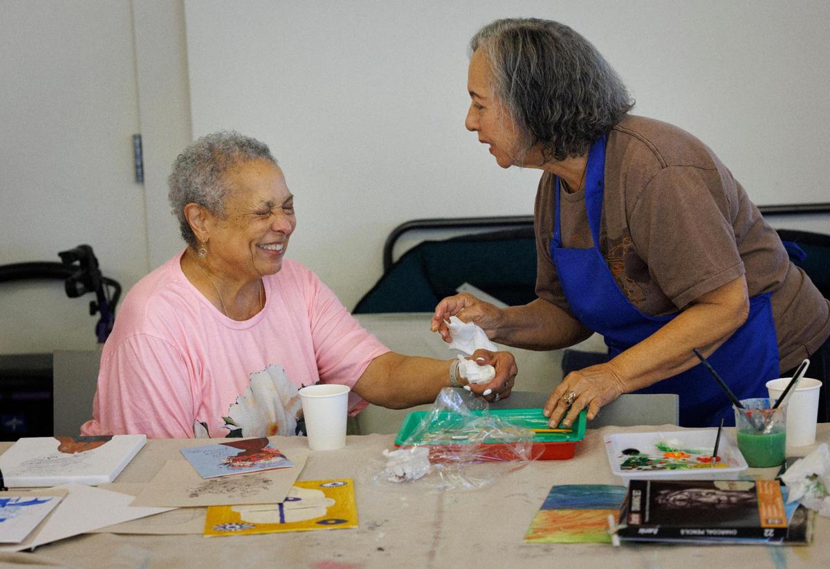 Jacqui Love Thornell, left, smiles while talking to Mirna De Los Santos during open studio time in an art class for people over 55 years of age at Perez Art Museum Miami in downtown Miami. “This class felt sacred,” said Thornell while reflecting on her experience.
