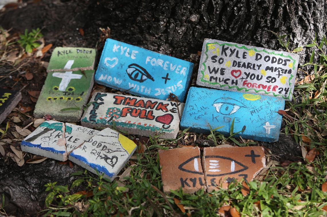 Remembrance bricks painted and placed by Cindy Dodds, under the tree on a street in Overtown where her son Kyle, at age 24, overdosed and died in September 2016.