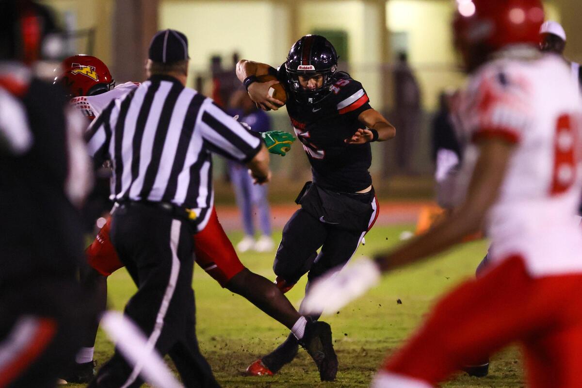 Southridge Spartans quarterback James Perrone (15) runs with the football against the Monarch Knights during the second quarter of a high school football playoff game at Southridge Park in Miami, Florida, on Friday, November 22, 2024.