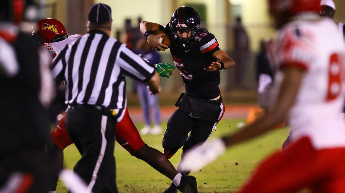 Southridge Spartans quarterback James Perrone (15) runs with the football against the Monarch Knights during the second quarter of a high school football playoff game at Southridge Park in Miami, Florida, on Friday, November 22, 2024.