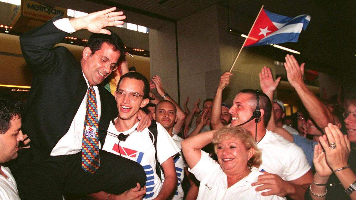 In 1998, Jorge Mursuli, of SAVE Dade, is hoisted in celebration after Miami-Dade commissioners voted to hold a public hearing on adding gay and lesbian people to those protected by the human-rights ordinance.