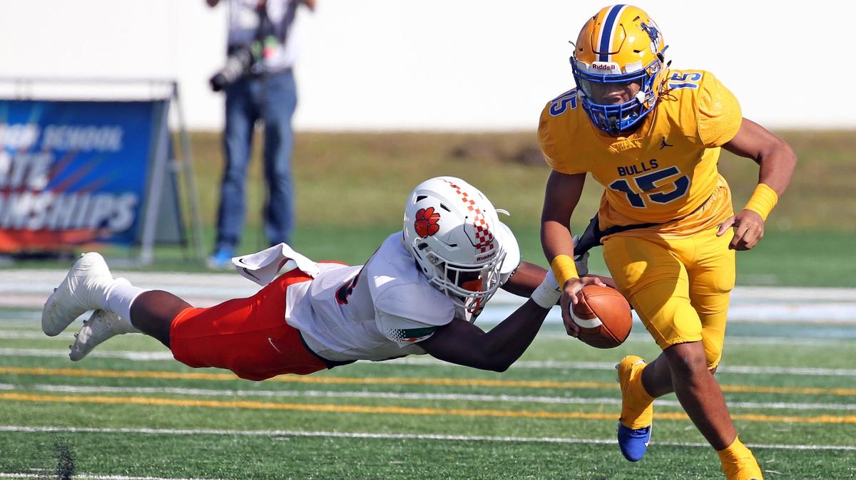 Northwestern quarterback Taron Dickens avoids a tackle by Orlando Jones’ Malik Bryant on Saturday as the freshman guided the Bulls to their third straight state championship.