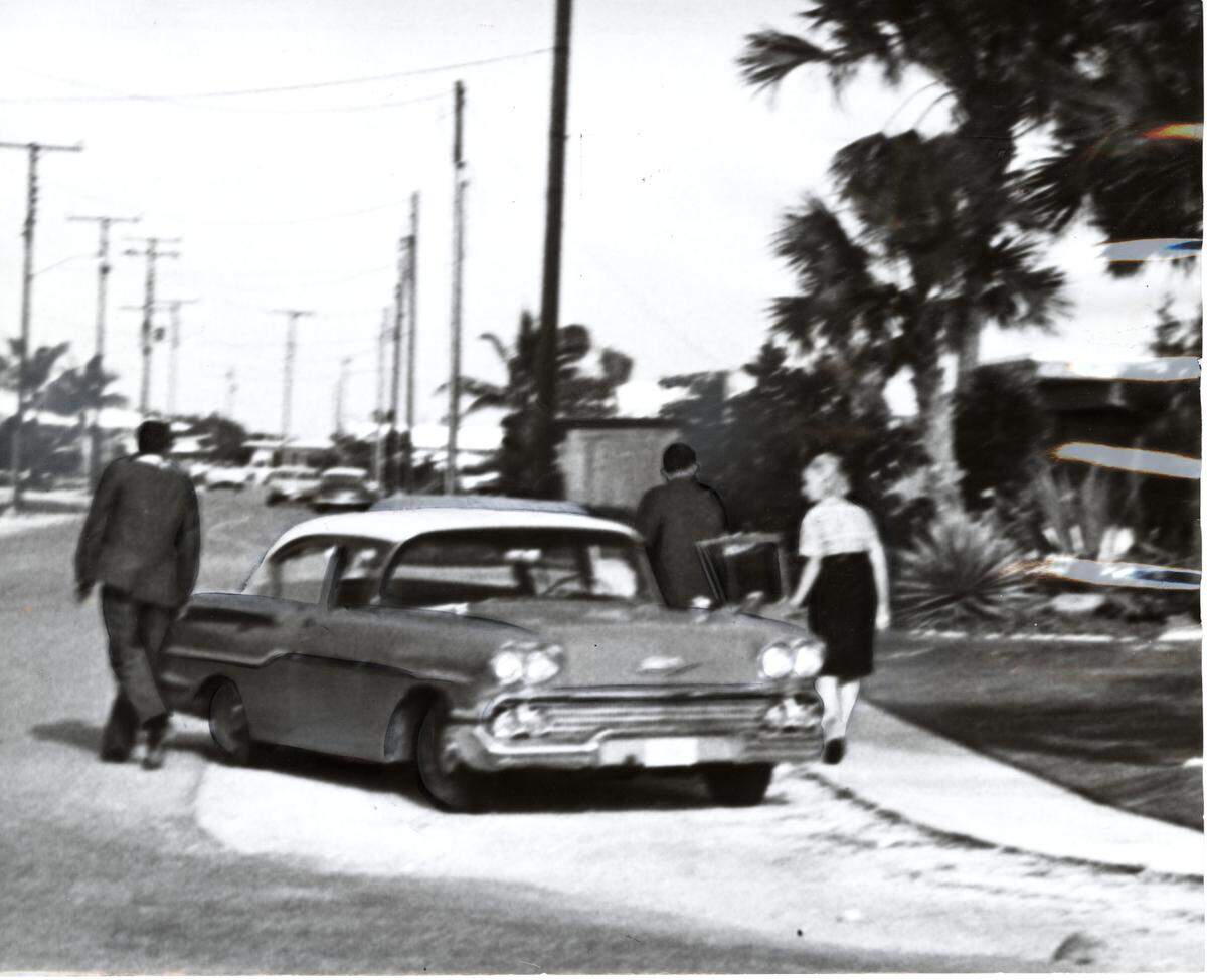 Homicide detectives return to Frances DiMare’s home after visiting the scene of the murder of her husband, Joseph DiMare, in 1961. 