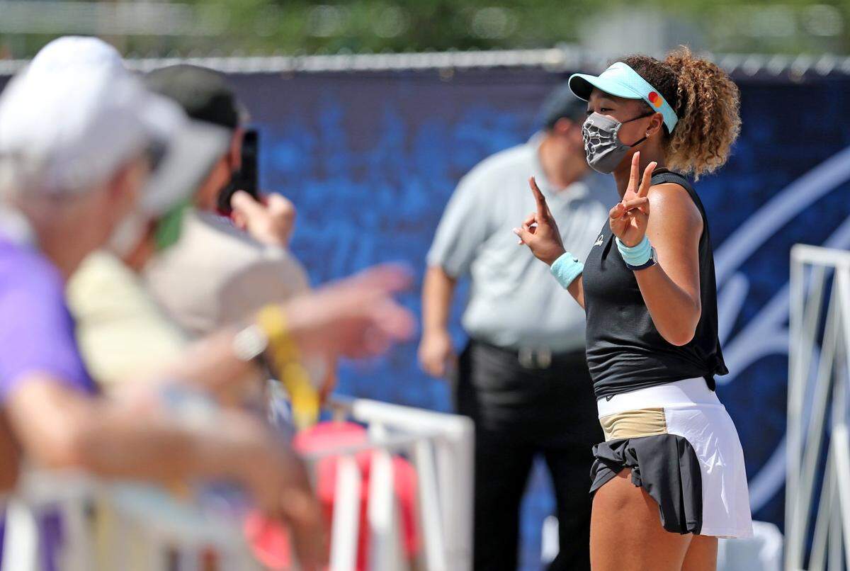 Naomi Osaka (JPN) greets her fans after defeating Ajia Tomljnovic (AUS) in the 2021 Miami Open at Hard Rock Stadium in Miami Gardens, Florida, Friday, March 26, 2021.