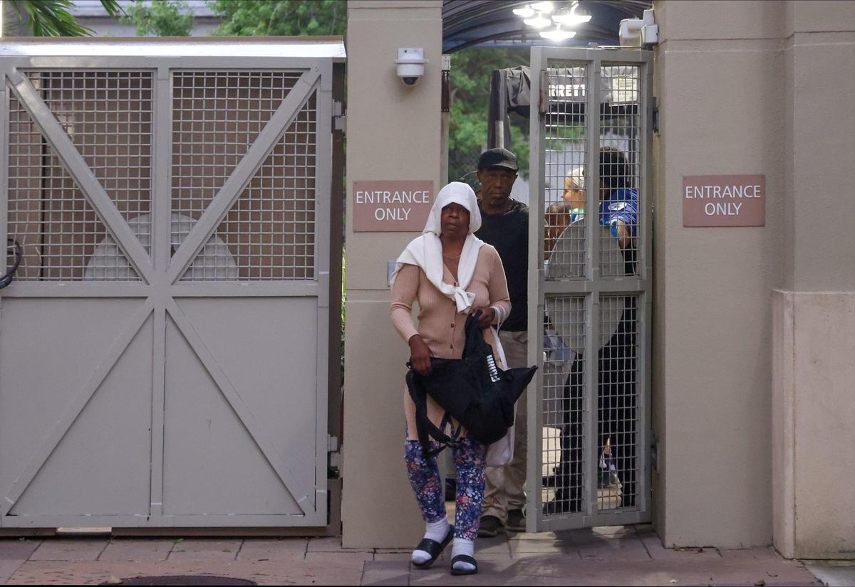Non-resident clients gather at Camillus House’s front gate as they wait to eat, charge their phones and bathe on Monday, Nov. 11, 2024, in Miami.