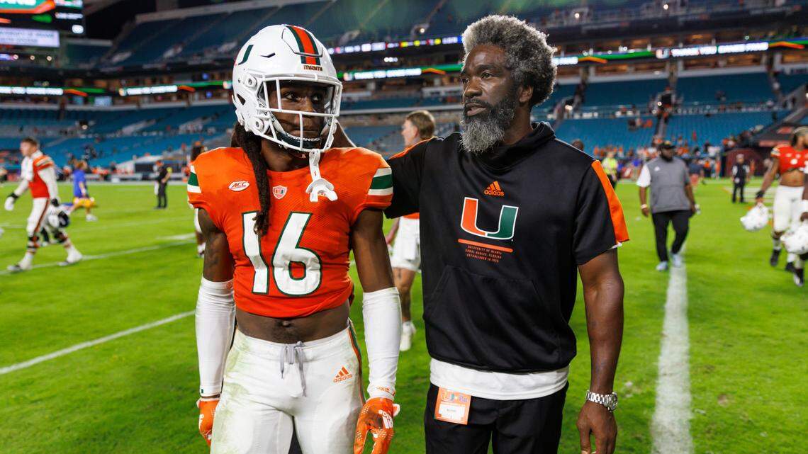 Miami Hurricanes cornerback Malik Curtis (16) and Hurricanes senior football advisor Ed Reed walk off the field after the Hurricanes lost to the Pittsburgh Panthers 16-42 during an ACC conference football game at Hard Rock Stadium on Saturday, November 26, 2022 in Miami Gardens, Florida.