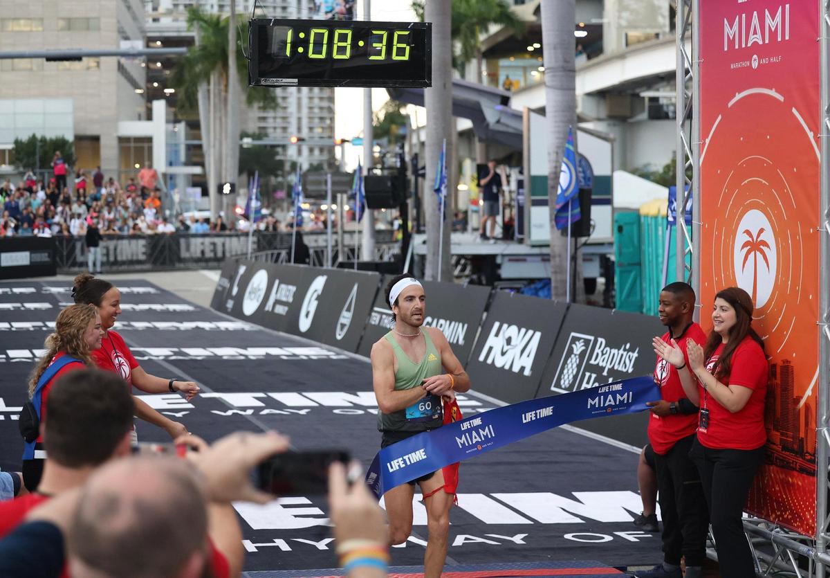 Life Time Half Miami Marathon men’s winner Nacho Hernando Angulo, 29, of United States, crosses the finish line after completing the race on Sunday, Jan. 29, 2023, in Miami Fla.